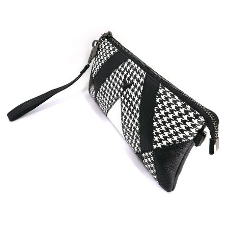 Angled view of the patchwork clutch bag.