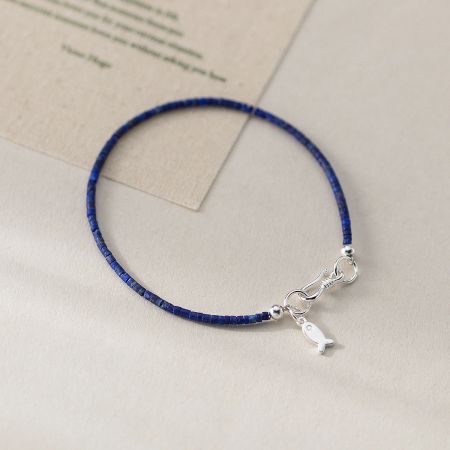 Close-up of a single strand 925 sterling silver lapis lazuli fish bracelet, highlighting its minimalist design.
