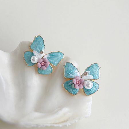 Angled view of the butterfly stud earrings showing the gold accents and fine craftsmanship.