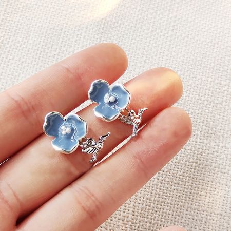 Vintage Silver Plated Blue Enamel Drop Bee Bird Charm Stud Earrings (5 Pairs) - A set of vintage silver-plated stud earrings featuring blue enamel flowers and dangling bird charms, displayed on a neutral background.