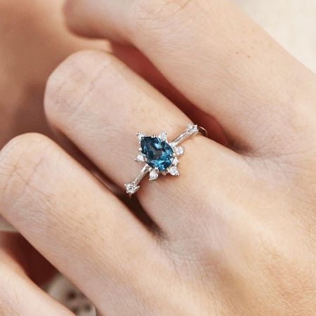 Detailed side view of the Ocean's Heart blue zircon ring, highlighting the intricate setting.