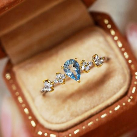 Another view of the aquamarine ring elegantly displayed in its jewelry box.