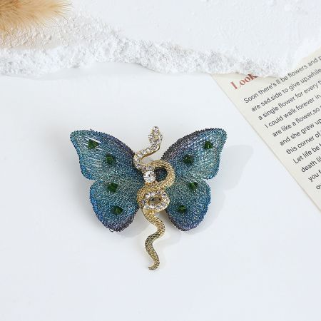 The Snake Embroidery Butterfly Brooch in a stunning blue and gold color combination.