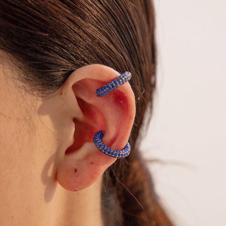 Close-up of the blue rhinestone ear cuff, highlighting the vibrant color and detailed craftsmanship.