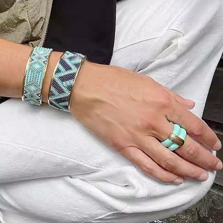 Detailed shot of the vintage enamel rings, highlighting the vibrant blue-green color and craftsmanship.