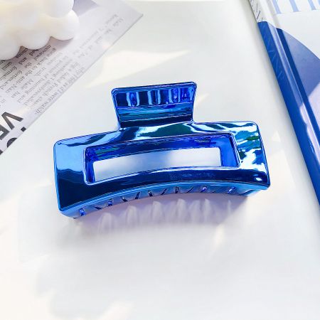Close-up of the blue hollow square metal hair clip.