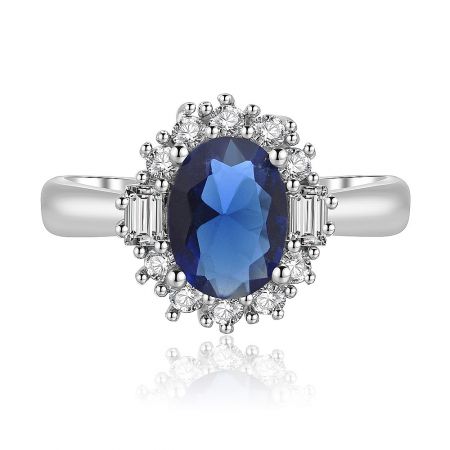 Single Oval Sapphire Zirconia Ring - Front view of the Single Oval Sapphire Zirconia Ring, showcasing the brilliant blue center stone and sparkling zirconia halo on a rhodium-plated band.