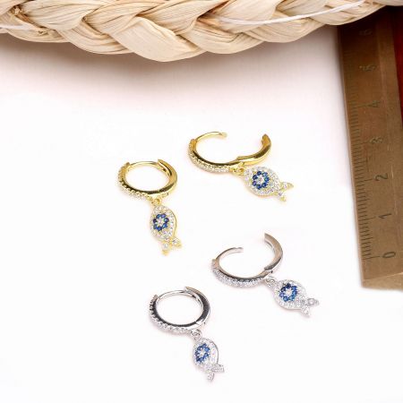 925 Sterling Silver Ocean Fish Huggie Hoop Earrings (Set of 5 Pairs) - A collection of 925 sterling silver ocean fish huggie hoop earrings, showcasing both gold and silver finishes with intricate fish and leaf charms adorned with blue gemstones.