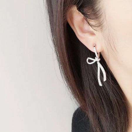 Model wearing the sweet CZ bow knot silver earrings to showcase their elegant look.