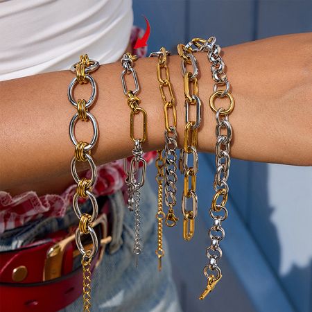 Model wearing the full set of five gold and silver two-tone bracelets, demonstrating a stylish stacked look.