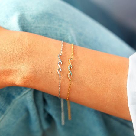 A model wearing two Glittering Waves bracelets to showcase a layered look.