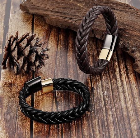 Two braided leather bracelets, one in black and one in dark brown, displayed together to show the available styles.