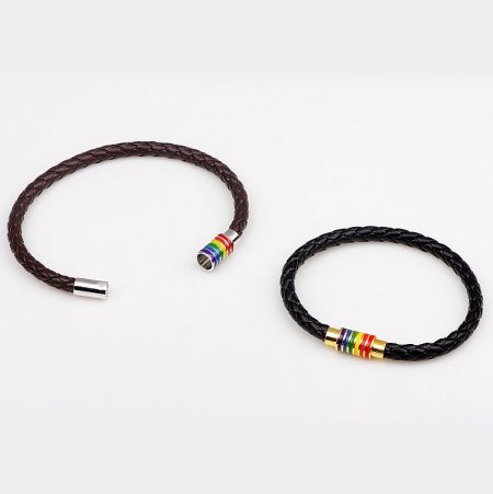 Two braided leather bracelets, one black and one brown, both with rainbow enamel clasps.