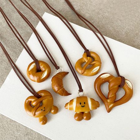PU Bread Pendant Necklace Bag Charm Keychain - Set of 5 - A collection of five different handcrafted PU bread-shaped necklace pendants, including pretzel and croissant designs, available for wholesale from JR Fashion Accessories.