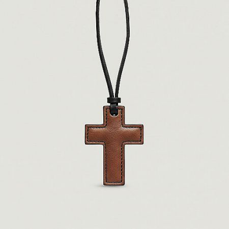 Front view of a simple yet elegant brown leather cross charm.