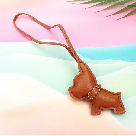 A classic brown leather dachshund-shaped keychain accessory.