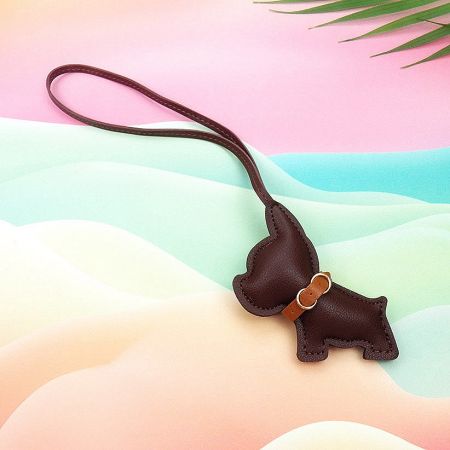 Detailed view of a brown leather dachshund keychain with a collar.