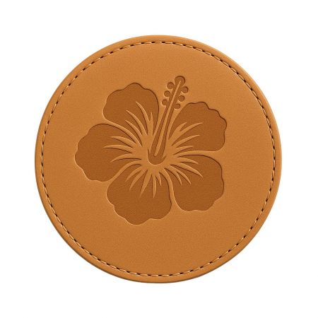 Elegant brown leather coaster with an embossed hibiscus flower design.