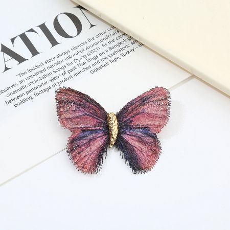 Close-up of a single vintage butterfly brooch with intricate details.