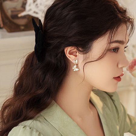 Fashion portrait featuring the stylish butterfly earrings.