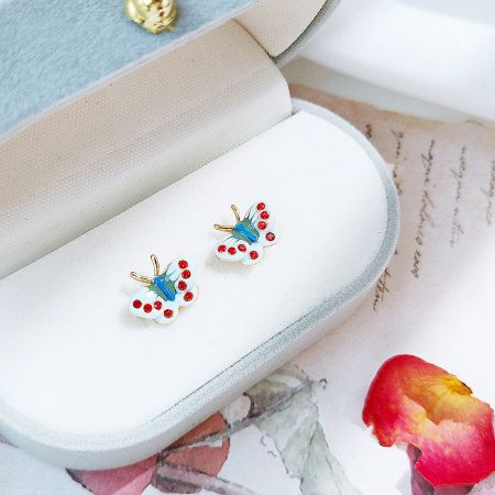 The set of butterfly earrings elegantly displayed in a light blue jewelry box.