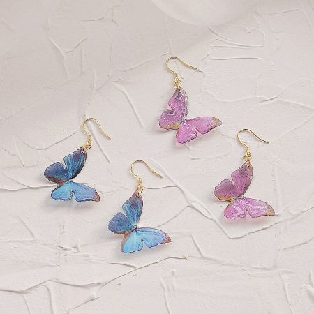 Four pairs of butterfly earrings in blue and purple.
