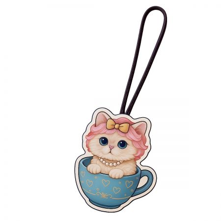 Whimsical cartoon cat keychain sitting in a blue teacup, an example of custom UV printed accessories.