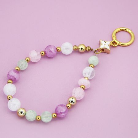 Pastel beaded phone charm with pink and green acrylic beads and a gold clasp.