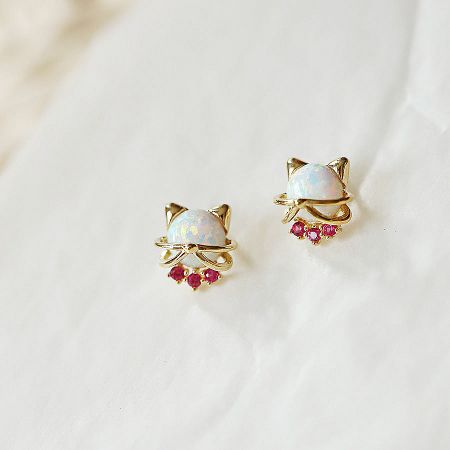 Pair of silver cat stud earrings with opal stones.