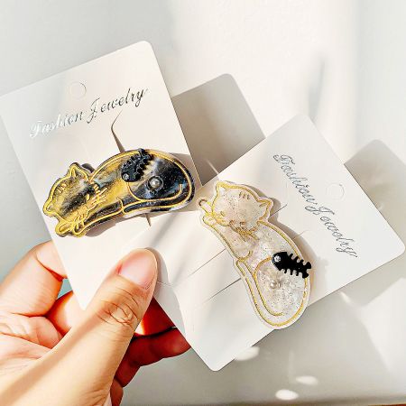 Two cat-themed hair clips displayed side-by-side, showing the elegant design.