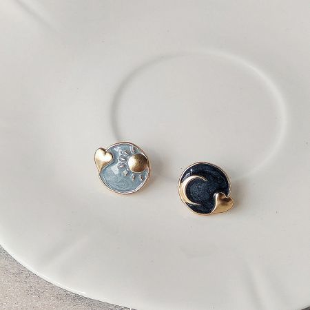 Two pairs of celestial-themed earrings, one with a sun and one with a moon, on a white background.