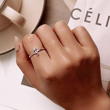 A stylish silver ring featured in a promotional lifestyle shot.
