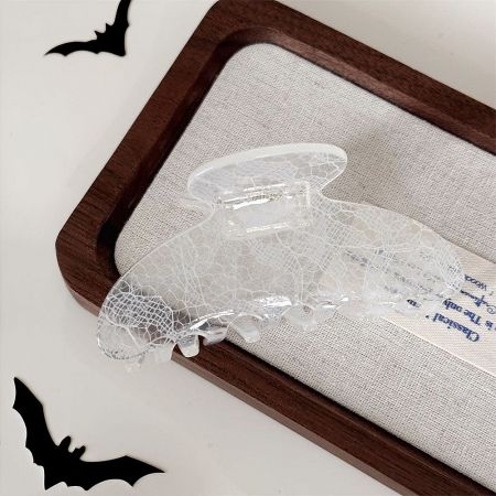 Detailed view of the intricate lace design on the clear hair clip.