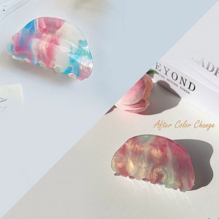 Close-up of a color-changing hair clip, showcasing its unique marbled pattern.