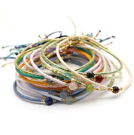 A close-up view of several faceted bead strand bracelets, showing the detail and vibrant colors of the plastic beads.