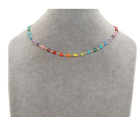The colorful beaded flower necklace displayed on a mannequin to show how it looks when worn.