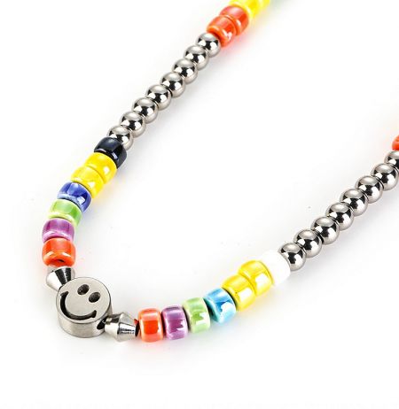 Close-up of the colorful beaded necklace with a prominent smiley face charm, highlighting the vibrant LGBT pride colors.