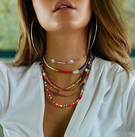Spring/Summer 2023 Jewelry Collection - A vibrant display from the Spring/Summer 2023 jewelry collection, featuring colorful beaded necklaces and elegant gold earrings, available for wholesale.
