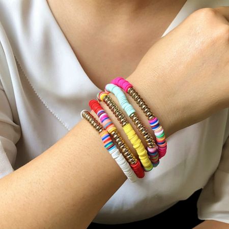 Hot Sale Hawaii Rainbow Colorful Bohemia Polymer Clay Gold Bead Bracelet - A close-up of a wrist adorned with the Hawaii Rainbow Colorful Bohemia Polymer Clay Gold Bead Bracelet, showing its vibrant colors and gold bead details.