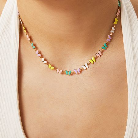 Stainless Steel Colorful Enamel Butterfly Charm Chain Collar Necklaces (Set of 5) - A close-up of a model wearing the stainless steel necklace with colorful enamel butterfly charms, highlighting its delicate design against a white top.