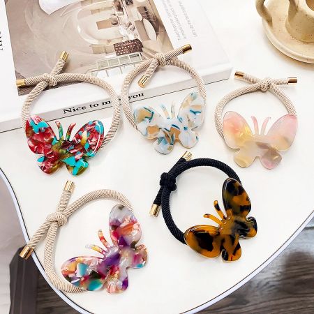 An assortment of butterfly hair clips with unique marbled designs, displayed elegantly.