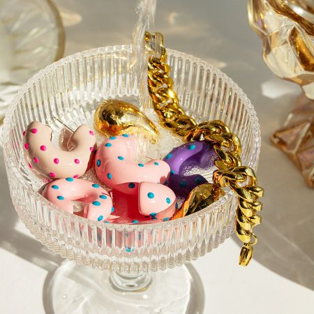 Stainless Steel Colorful Enamel Y2K Vintage Style Cuff C-Shape Hoop Earrings (Set of 5 Pairs) - A collection of colorful stainless steel enamel Y2K vintage style cuff C-shape hoop earrings displayed in a clear glass dish.