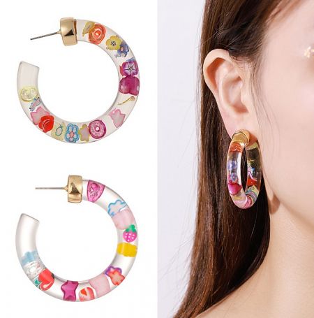 A close-up view of colorful floral hoop earrings made from acrylic, highlighting their intricate and vibrant design.