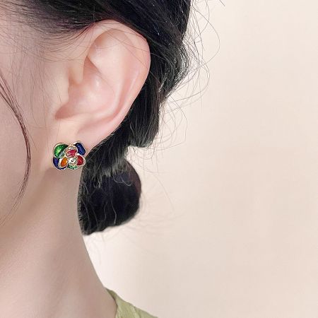 A model wearing the multi-color enamel 3D flower stud earring to showcase its size and appearance.