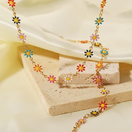 Vibrant colorful enamel daisy flower necklace on a gold chain.