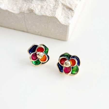 A close-up view of the pair of 3D flower stud earrings, highlighting the intricate gold trim and enamel work.