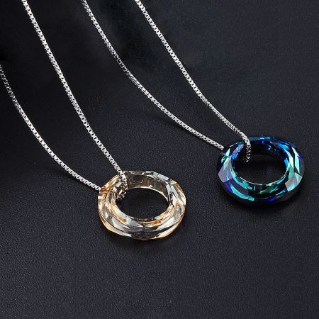 A pair of crystal circle pendant necklaces showcasing different color variations available in the set.