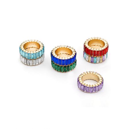 A collection of four eternity stack rings in different color variations.