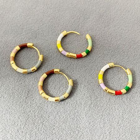 Four pairs of colorful gold hoop earrings showcasing different vibrant enamel color combinations.