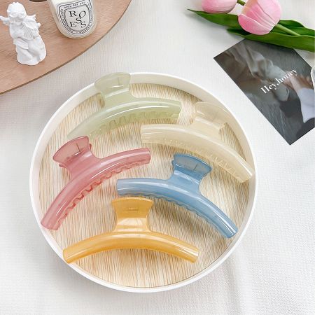 Arc Shape Hair Claw Clip for All Hair Types (Set of 5) - A collection of colorful arc-shaped hair claw clips displayed in a white bowl, showcasing the variety available in the 5-piece set.